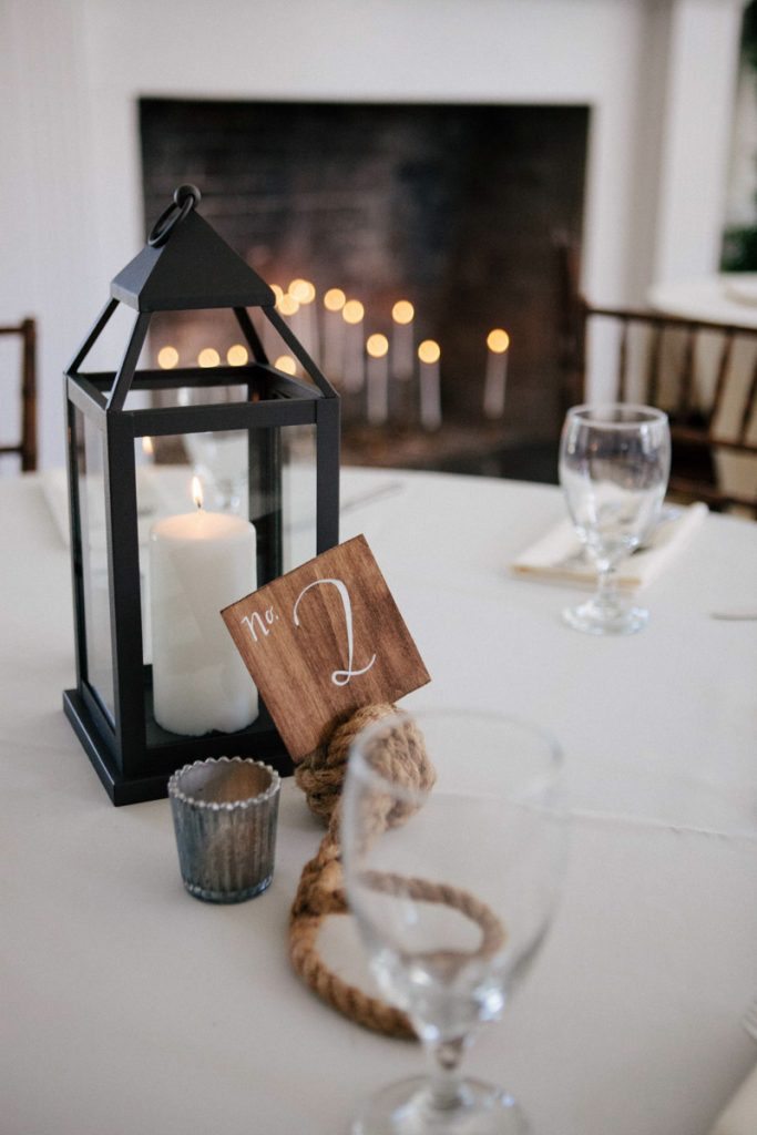 Black lantern table centerpiece nautical table number candle fire place Hunter_Gibney_Ais_Portraits_AisPortraitsGibneyRibaultWedding665